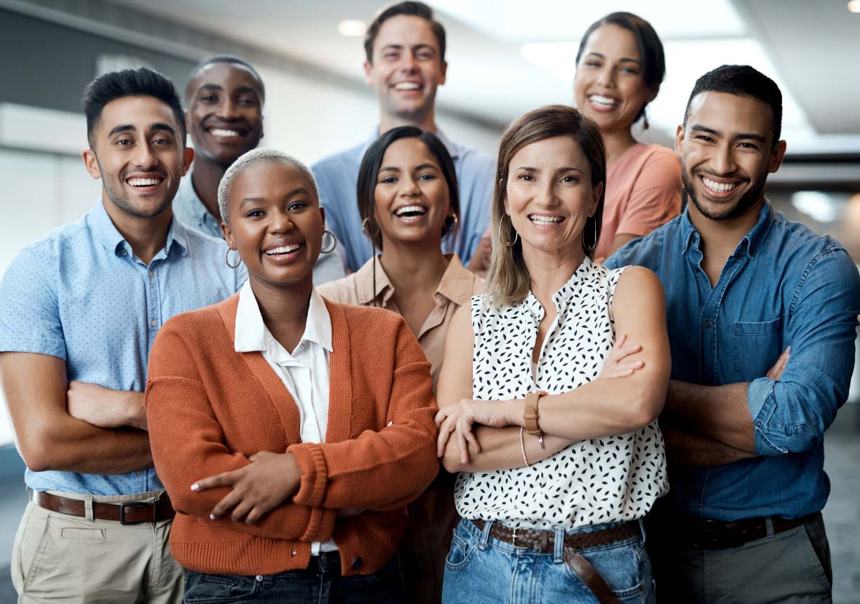 group of racially and gender diverse office workers smiling for camera
